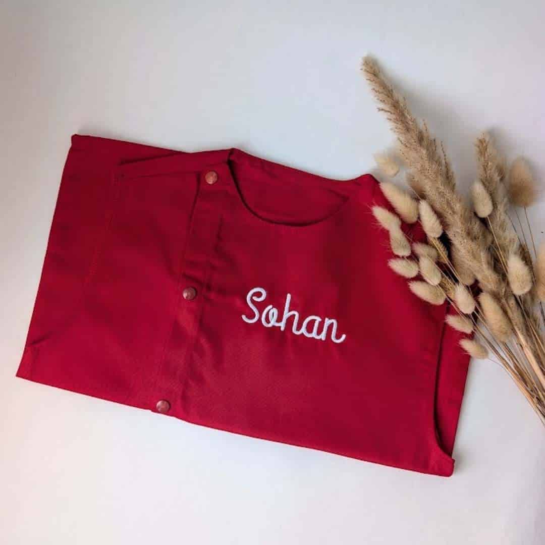 tablier maternelle rouge personalisé (9) Tablier en tissus pour école maternelle couleur vert modèle sans manches pour garçon brodé du prénom Sohan en blanc